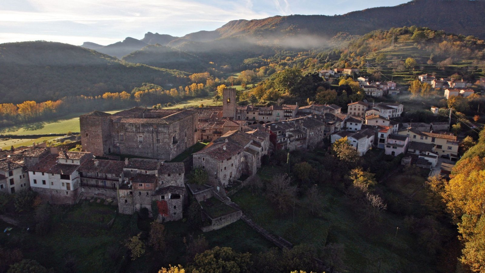 Paisaje de La Garrotxa con montañas, bosques y cielos despejados, en el Parque Natural de la Zona Volcánica.